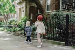children walking in a neighborhood